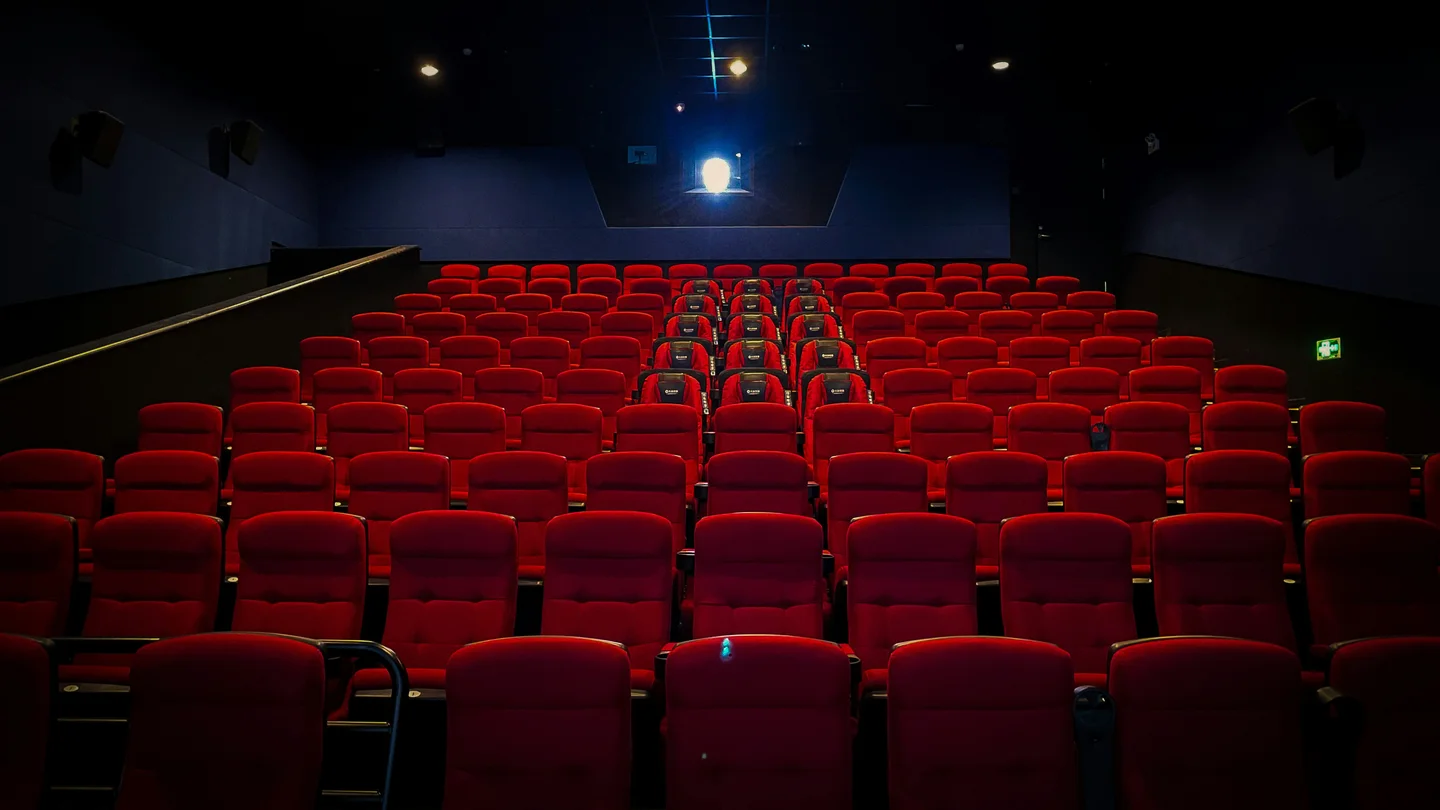 Rows of red seats in a cinema auditorium